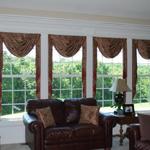 Betty Maxwell chose a faux silk with beaded fringe for her living room.  This style with the stacked cascades (the long parts on the sides) shows off their view of the world and enhances the incredible woodwork framing it all.