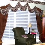 An elegant window treatment for a bedroom that still reveals the gorgeous woodland view when the Hunter Douglas Silhouette shades are open.