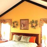 The woman of the house wanted something beautiful for the master bedroom of this country lodge.  The man of the house wanted to be able to see the white tails of the deer on his ridge.  By raising the treatments, both were happy!