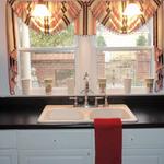 Simple swags and cascades in this cottage kitchen are not only cheery, but reveal the view of the outdoor courtyard.